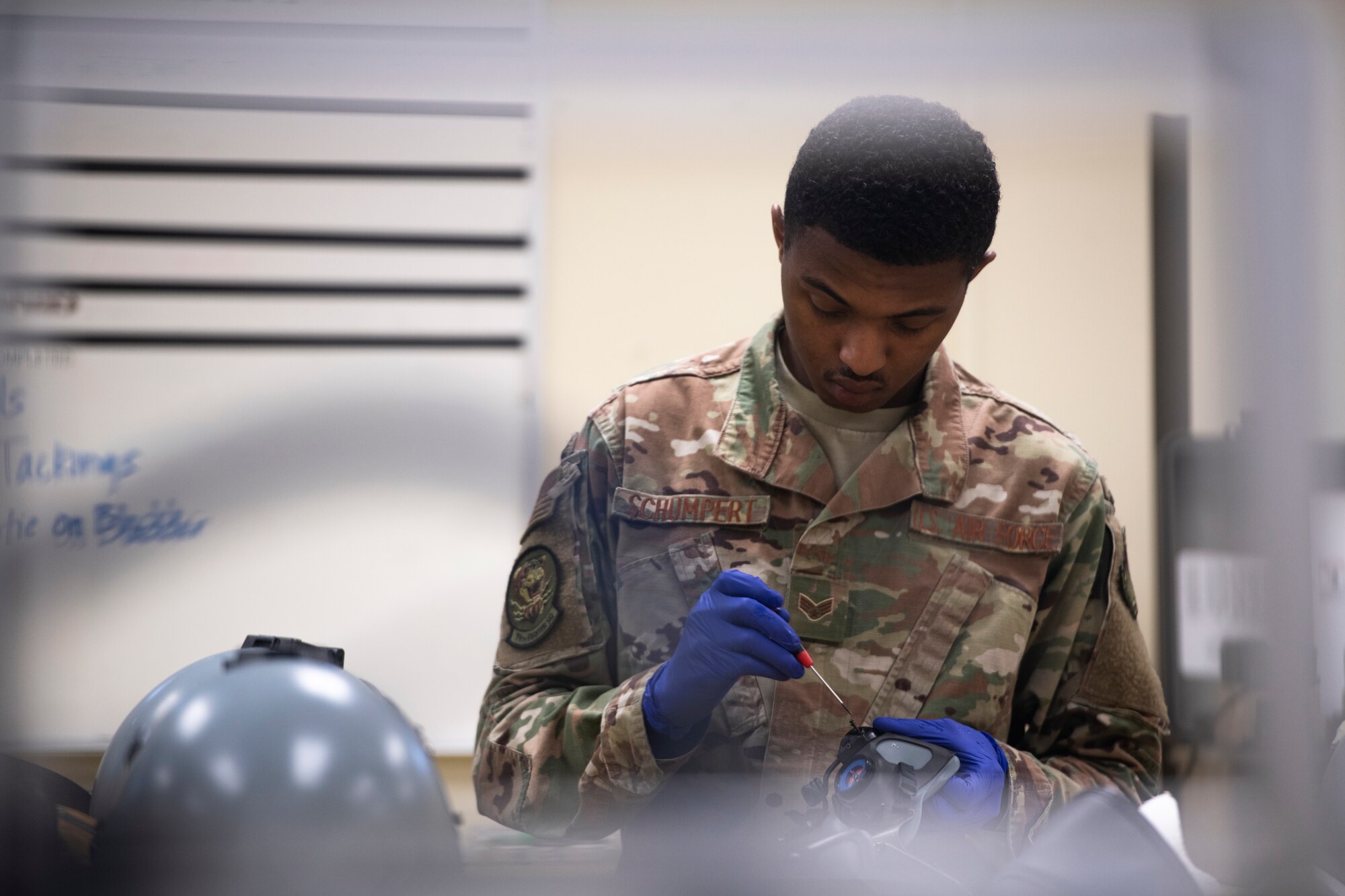 U.S. Air Force Senior Airman Devin Schumpert, 20th Operations Support Squadron aircrew flight equipment (AFE) technician, applies safety wire to a piece of flight gear at Shaw Air Force Base, S.C., May 8, 2019.