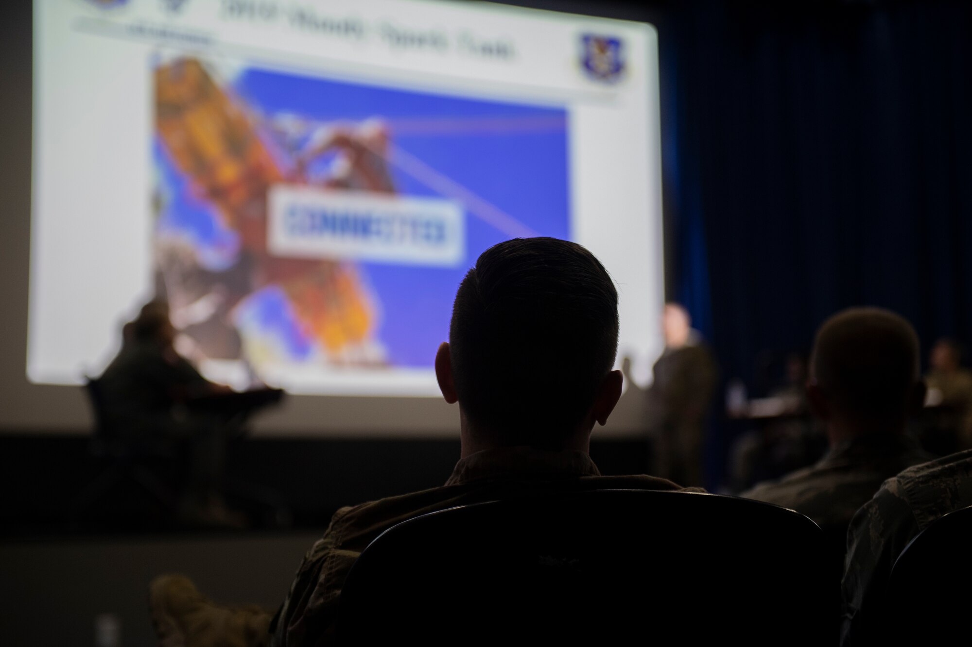 A member of the audience watches as a team presents an idea during the annual Moody Spark Tank competition May, 3, 2019, at Moody Air Force Base, Ga. The competition allows Airmen to showcase their ingenuity by presenting various time and money saving ideas that can benefit the Air Force. (U.S. Air Force photo by Airman 1st Class Joseph P. Leveille)