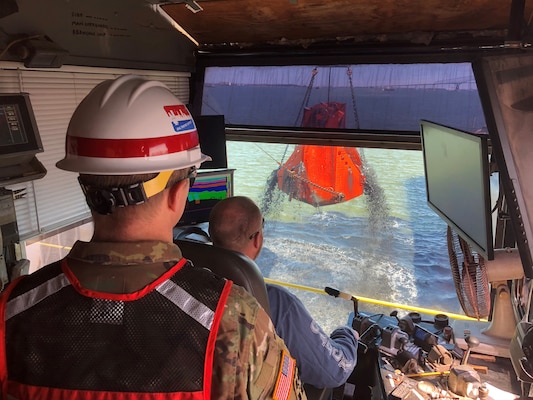 U.S. Army Corps of Engineers, Baltimore District Deputy Commander Lt. Col. Geoffrey Kuhlman looks on aboard an Army Corps contracted dredge operated by Norfolk Dredging as a load of material is pulled from the bottom of Curtis Bay Channel in Baltimore Harbor Tuesday March 19, 2019 as part of maintenance dredging of channels associated with the Baltimore Harbor and Channels Project. Curtis Bay Channel was one of six dredged during the Fiscal Year 2019 maintenance cycle, during which crews removed nearly 2.6 million cubic yards of material from channels to ensure continued safe navigation for vessels traveling to and from Port of Baltimore facilities.