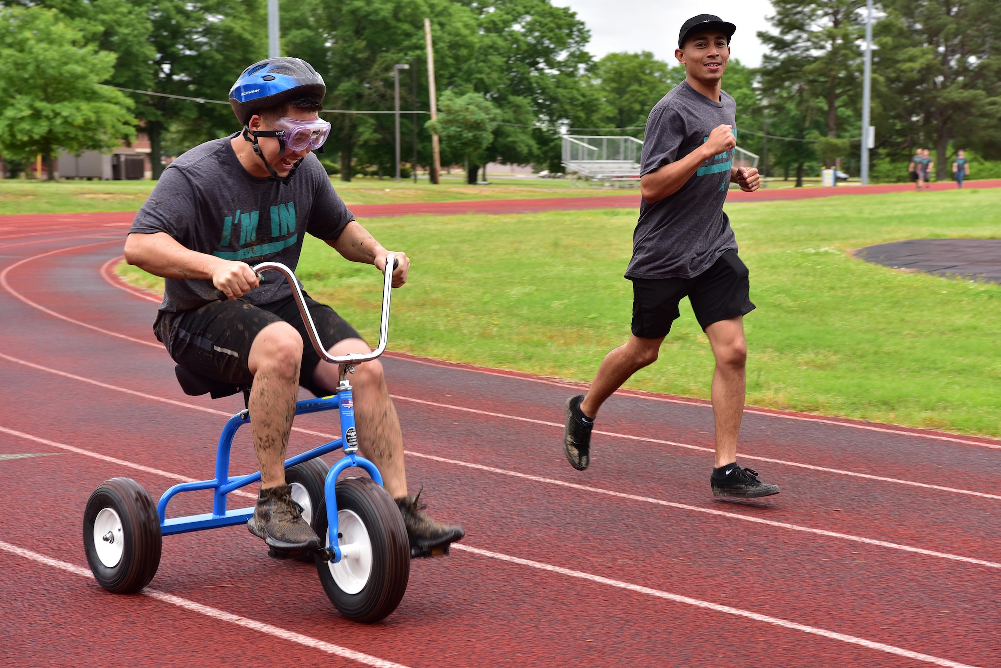 An Airman rides a tricycle during SAPR CLEAR challenge.