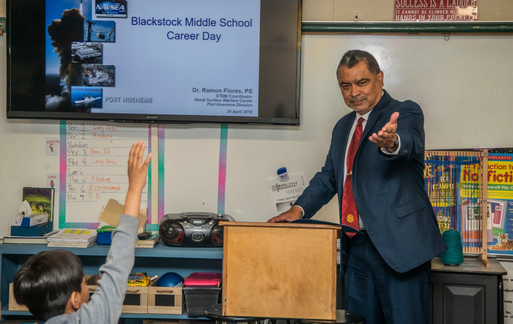 Ramon Flores, the science technology engineering and mathematics (STEM) coordinator at Naval Surface Warfare Center, Port Hueneme Division gives a presentation to students at Blackstock Middle School as part of a career day event, April 26.