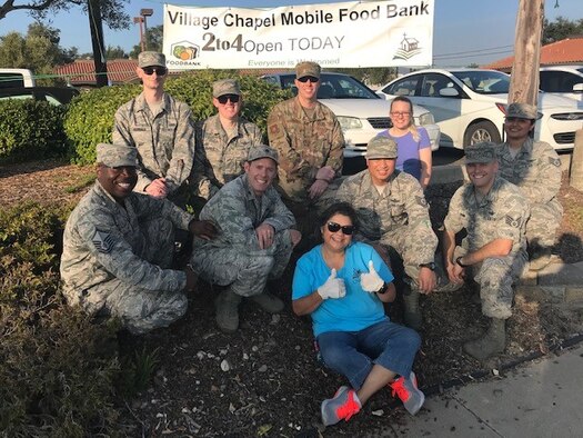 Volunteers from Vandenberg Air Force Base, Calif. and Norma Almanza, The Village Chapel Mobile Food Bank creator and event coordinator, pose for a phot after serving food at the mobile food bank Nov. 16, 2018, Vandenberg Village.