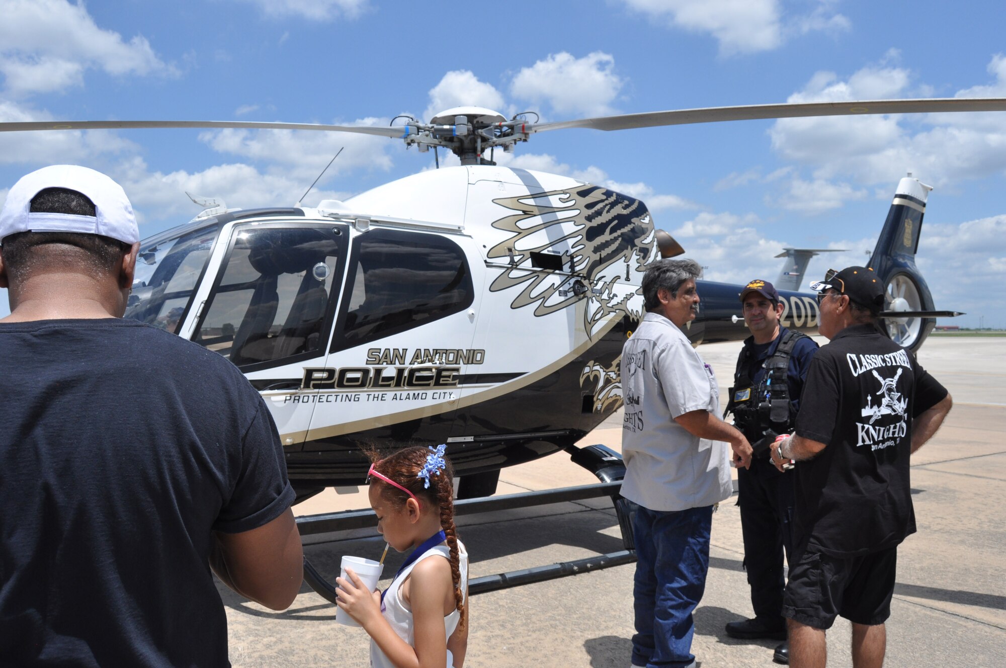 Jaime Valdez, San Antonio Police Department patrol pilot, spoke with guest at the 433rd Airlift Wing’s family day event May 5, 2019 at Joint Base San Antonio-Lackland, Texas.