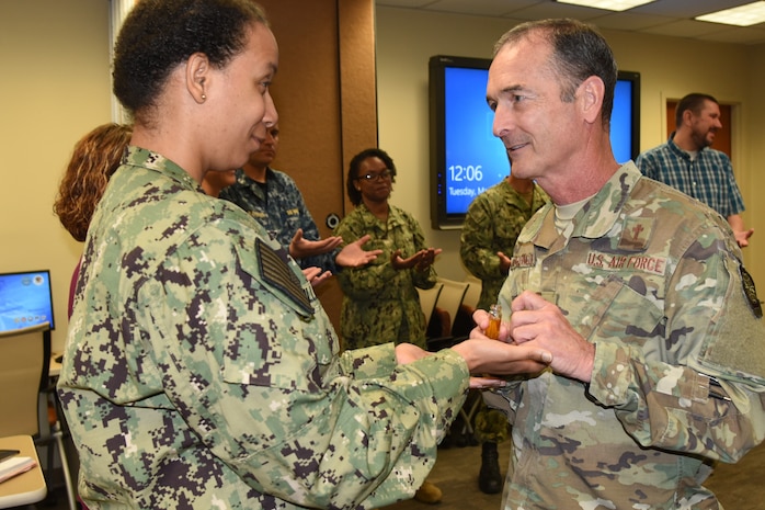 Air Force Lt. Col. Robert Johnson, 628th Air Base Wing chaplain, right, blesses the hands of Naval Health Clinic Charleston nurse, Lt. j.g. Lakesa Williams, during a "Blessing of the Hands" ceremony May 7, 2019, at NHCC located on Joint Base Charleston - Weapons Station, S.C., in celebration of National Nurses Week May 6-12.