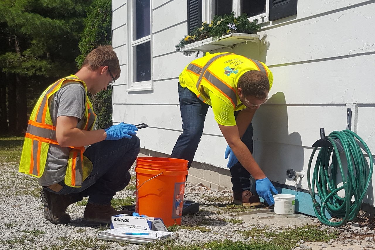 Workers sample drinking water