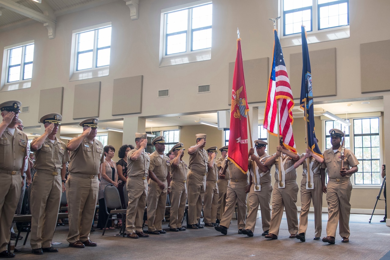 Sailors hold an indoor ceremony.