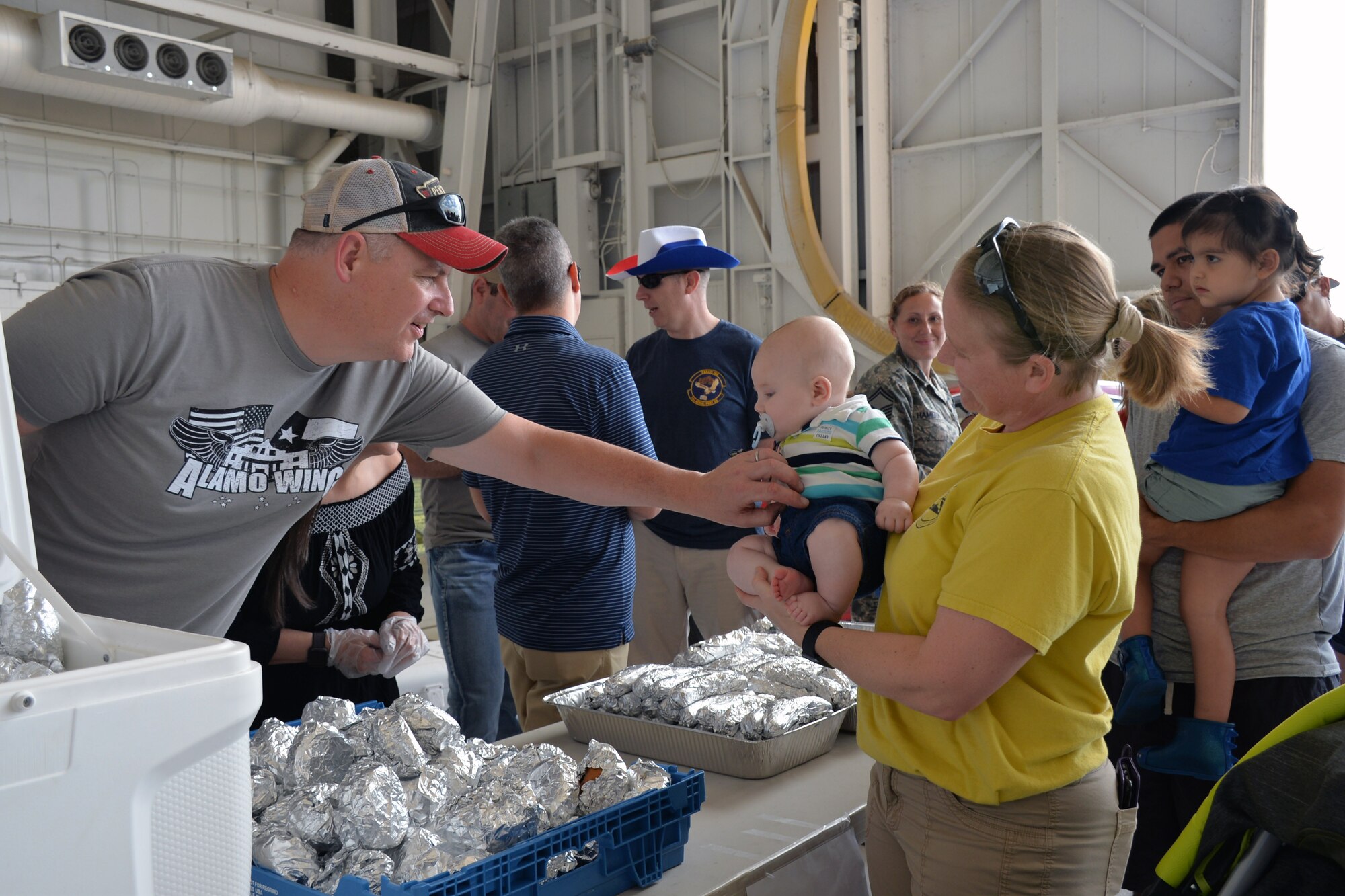 Col. Gregory Haynes, 433rd Operations Group commander, greets Sherry Justice, 356th Airlift Squadron operations superintendent, and her baby at the 433rd Airlift Wing family day May 5, 2019 at Joint Base San Antonio-Lackland, Texas.