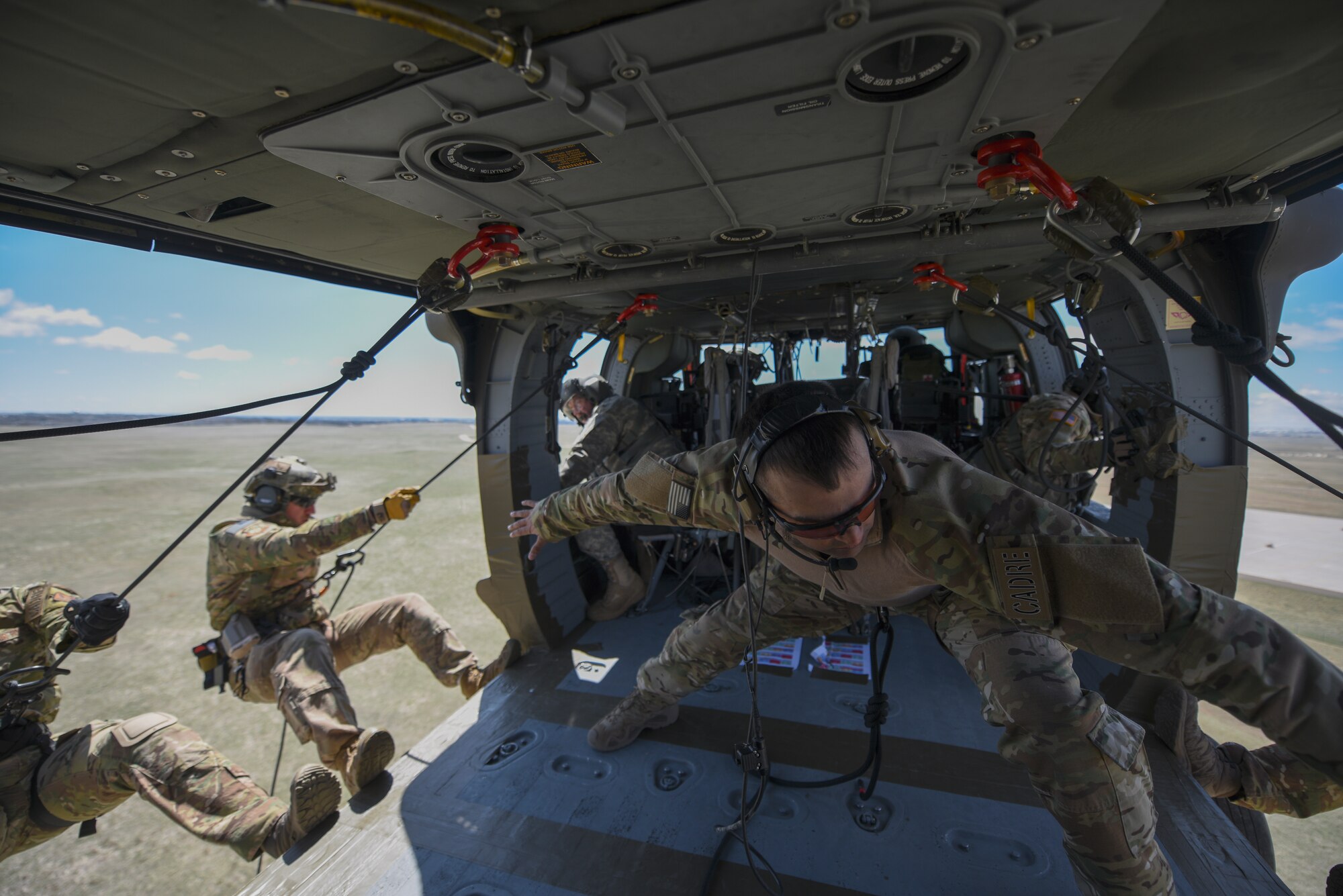 Airmen rappel out of an Black Hawk
