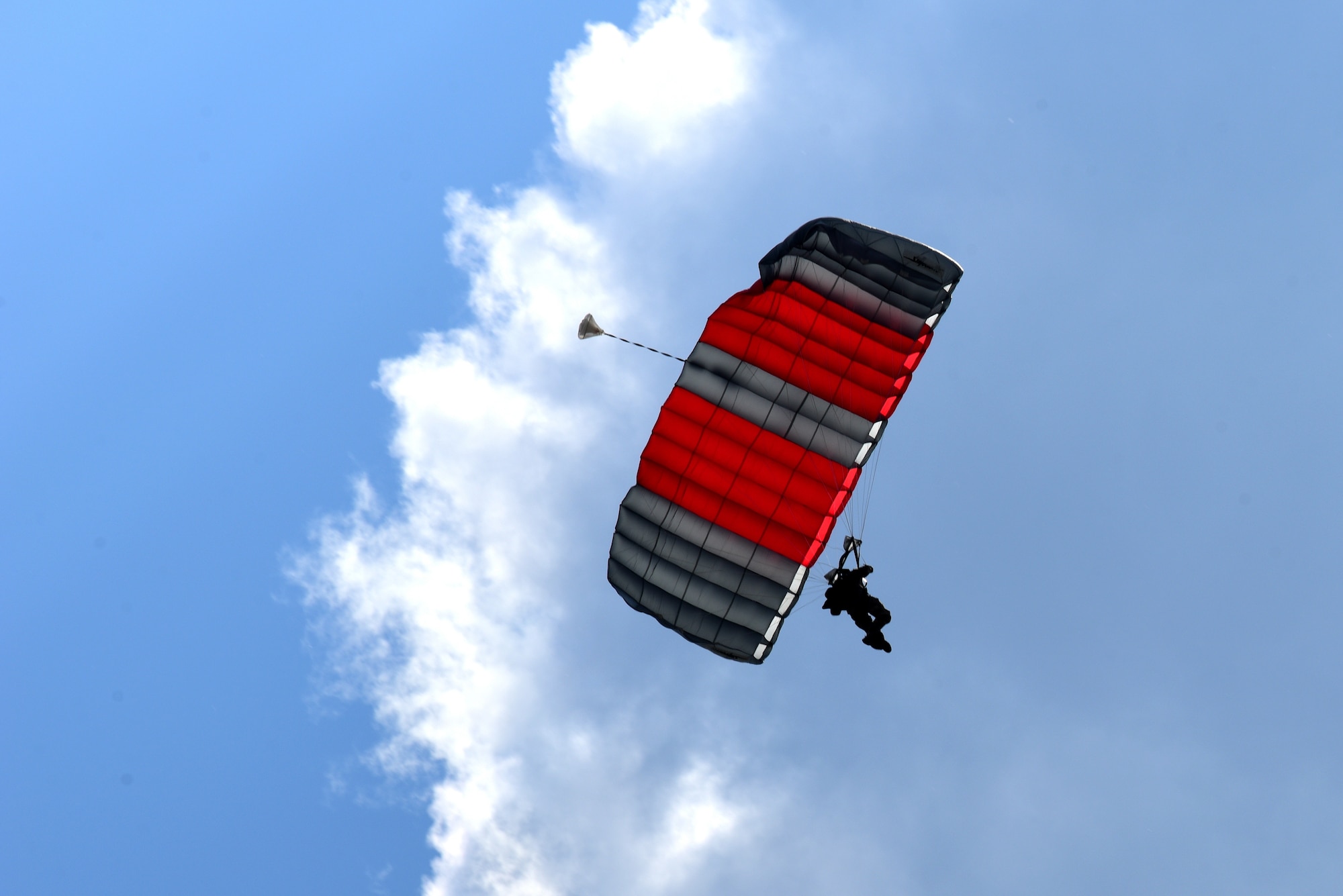An Airman parachutes onto the airfield