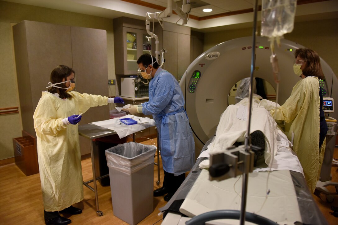 U.S. Air Force Captain Stephanie Smiddy, the infection and immunization officer-in-charge at the 180th Fighter Wing, Ohio Air National Guard, assists with a cancer treatment, April 8, 2019, at the University of Toledo Medical Center where she works as the head research nurse for the precision oncology department at the Eleanor N. Dana Center. Smiddy provides care for patients undergoing experimental immunotherapy treatments in the research program. (U.S. Air National Guard photo by Staff Sgt. Shane Hughes)