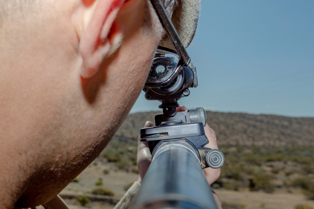 A Marine, with Headquarters Company, uses his rifle’s scope to view incoming enemies during a field training exercise aboard Marine Corps Logistics Base Barstow, Calif., May 9. (U.S. Marine Corps photo by Jack J. Adamyk)