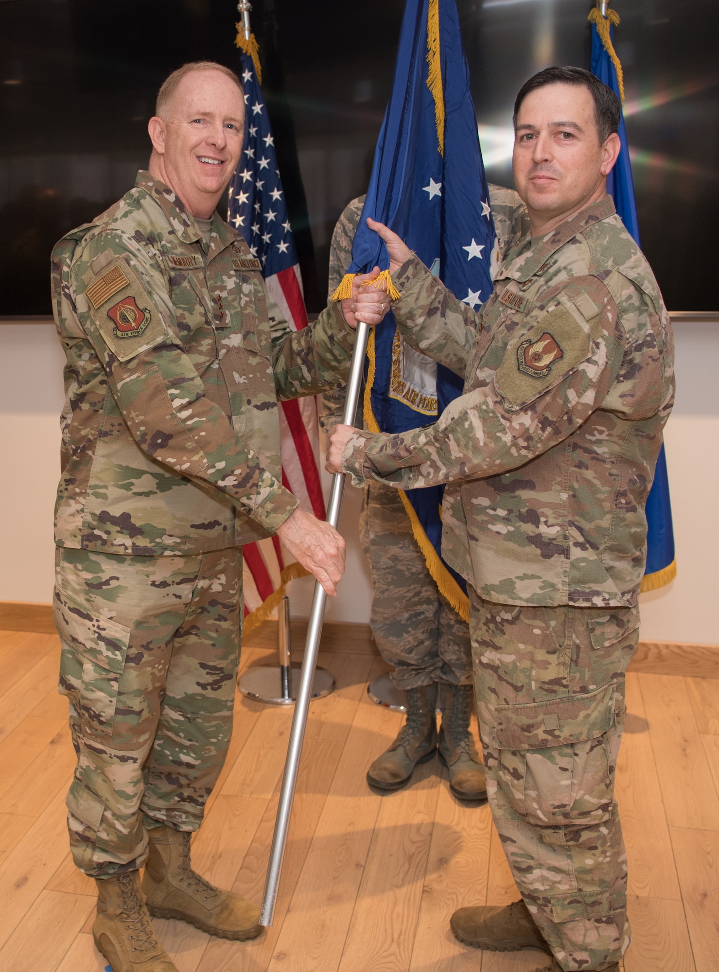 Col. Enrique Oti, right, receives the guidon for Air Force Life Cycle Management Center Detachment 12 from Center Commander Lt. Gen. Robert McMurry, left, May 8, 2019, during a detachment standup ceremony. Detachment 12’s mission is to create and rapidly deliver software and applications for U.S. warfighters. (U.S. Air Force photo by Jerry Saslav)
