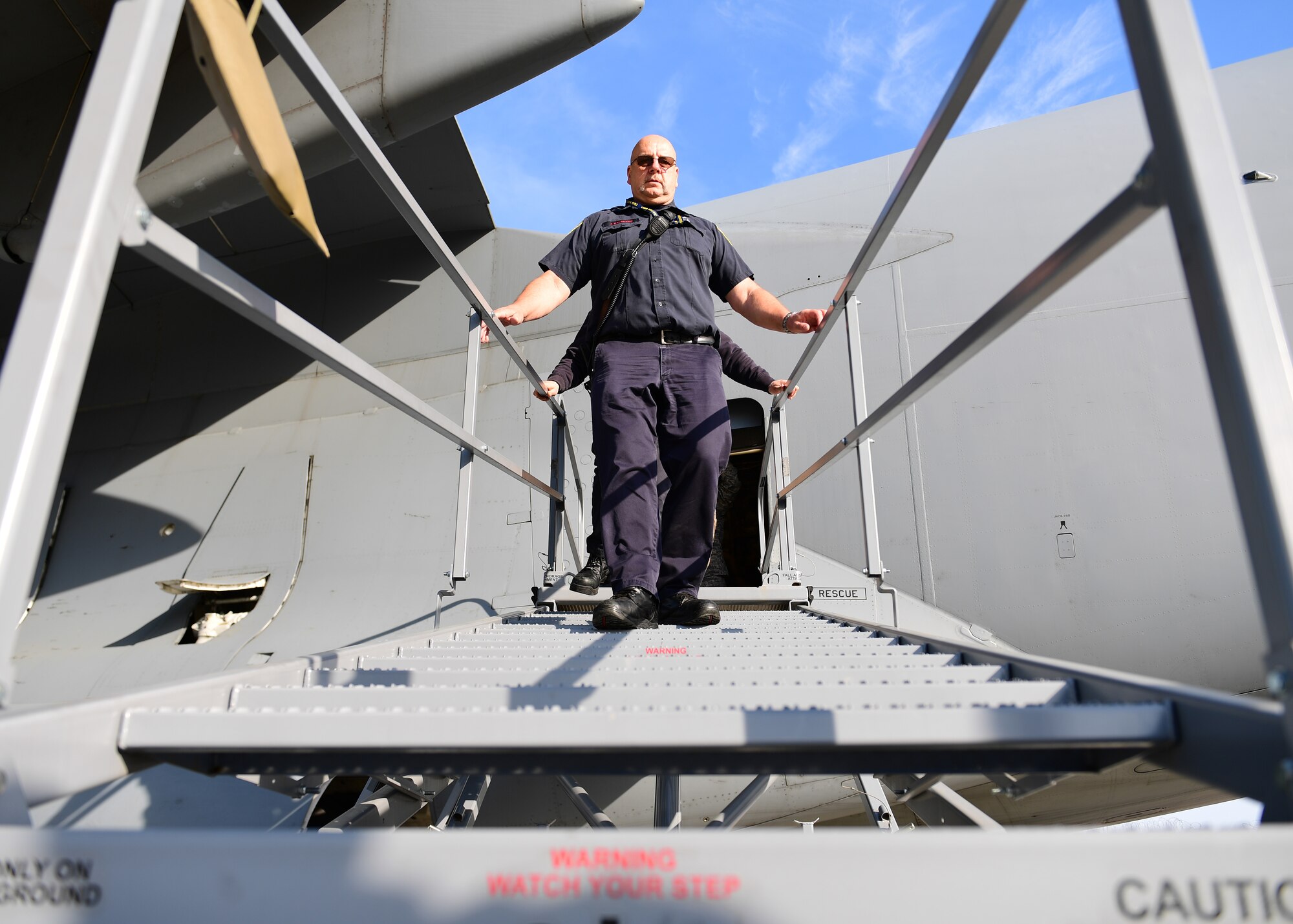 Jack Balkovec and Jarrod Barker, Allegheny County Airport Authority Fire Rescue firefighters, walk down the ramp of a B-2 stand at the Pittsburgh International Airport Air Reserve Station, Pennsylvania, May 9, 2019. The ACAA-FR firefighters received training on how to open emergency hatches from the outside of the C-17 Globemaster III. (U.S. Air Force Photo by Senior Airman Grace Thomson)