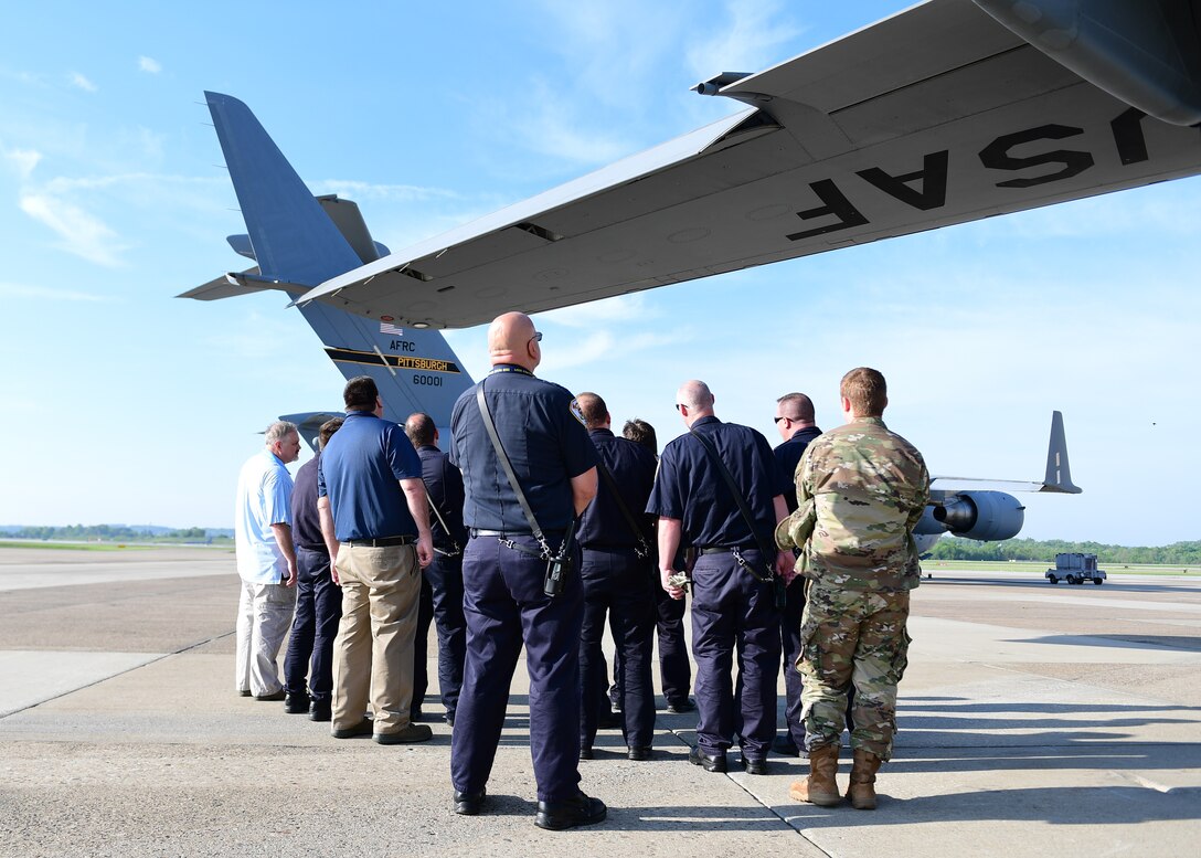 Members of the 911th Airlift Wing and the Allegheny County Airport Authority Fire Rescue team listen to instructions on wing fire control at the Pittsburgh International Airport Air Reserve Station, Pennsylvania, May 9, 2019. The 911th AW converted from C-130 Hercules to C-17 Globemaster III aircraft and the firefighters need to be trained on the new aircraft in case of an emergency. (U.S. Air Force Photo by Senior Airman Grace Thomson)