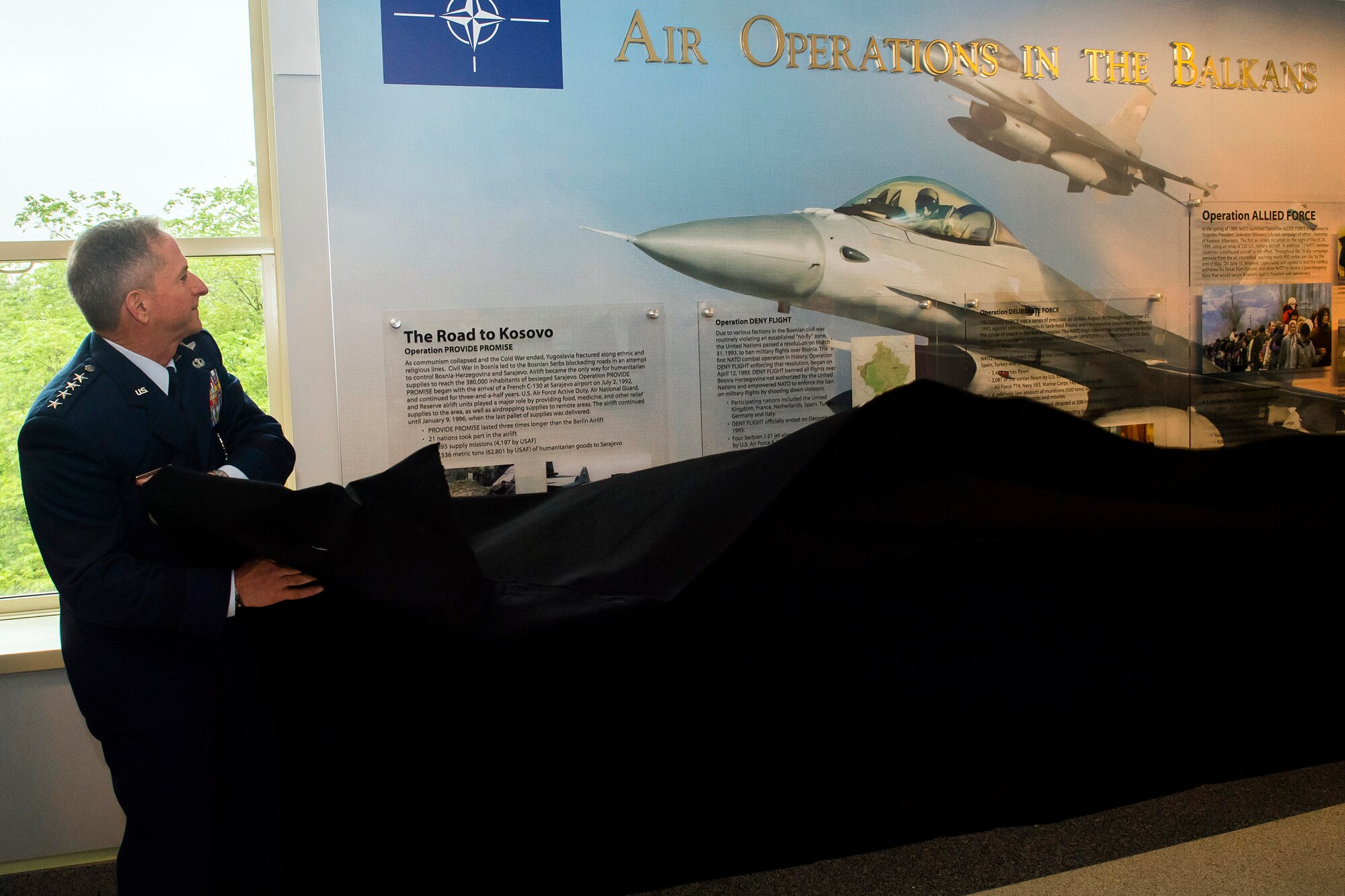 Air Force Chief of Staff Gen. David L. Goldfein pulls off a piece of cloth revealing a new display commemorating the 20th anniversary of Operation Allied Force during a ceremony at the Pentagon, Arlington, Va., May 8, 2019. Operation Allied Force was initiated in 1999 by NATO in response to Serbian President Slobodan Milosevic’s campaign of ethnic cleansing of Kosovar Albanians. (U.S. Air Force photo by Adrian Cadiz)