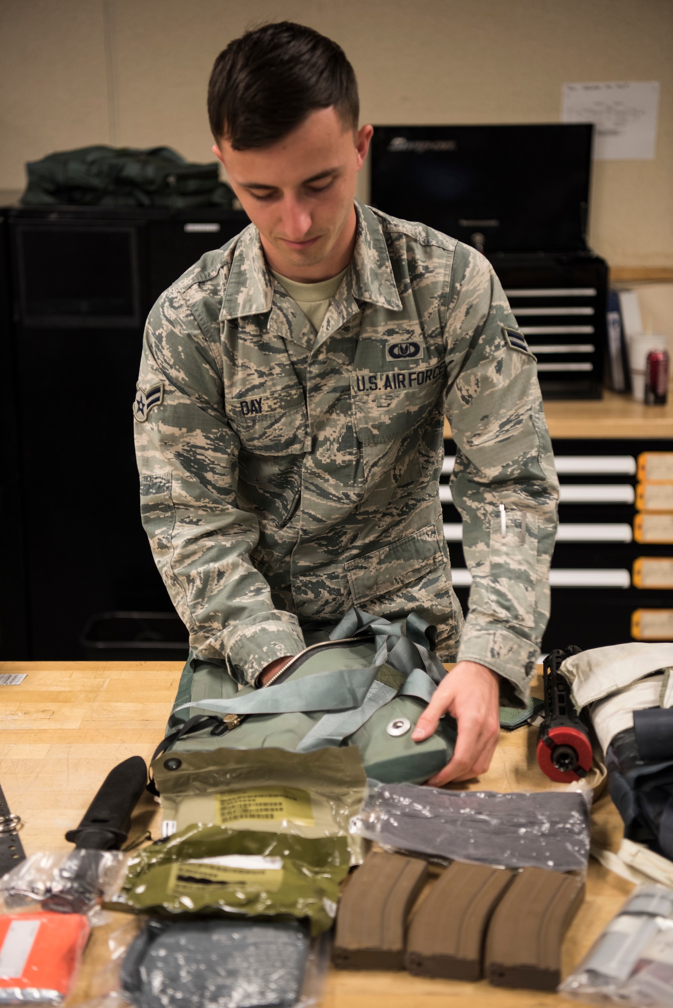Airman First Class Zack Day, 366th Operation Support Squadron aircrew flight equipment apprentice, packs an ACES II survival kit May 6, 2019, at Mountain Home Air Force Base, Idaho. The kit is provided for every aircrew member in the event they must eject during an emergency. It includes flares, a parachute, medical supplies, flotation devices, flashlight, weaponry and more. (U.S. Air Force photo by Airman First Class Andrew Kobialka)