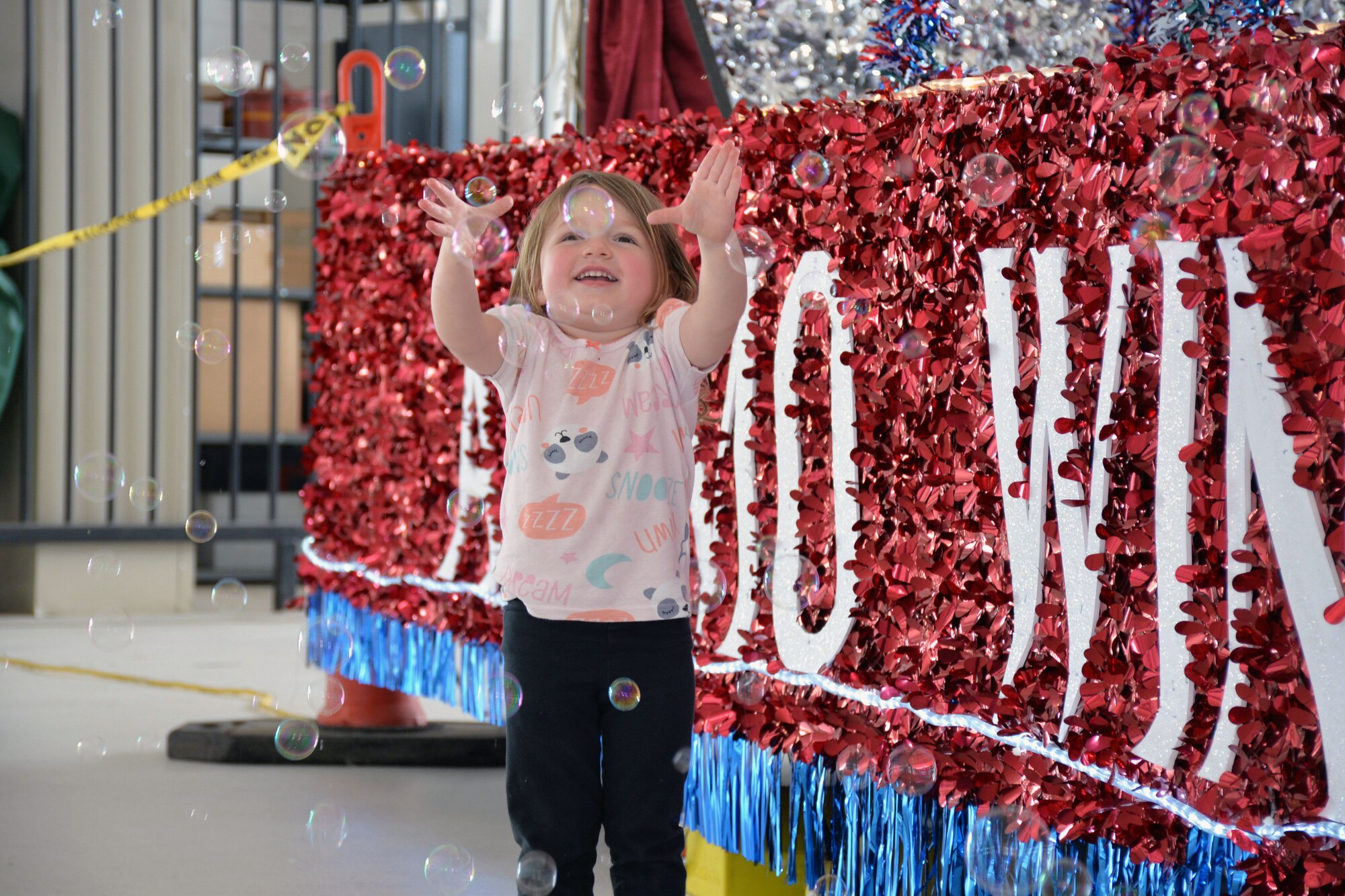 Abigail Harvey, daughter of Staff Sgt. Eileen Harvey, 26th Aerial Port Squadron, plays with bubbles at the 433rd Airlift Wing family day May 5, 2019 at Joint Base San Antonio-Lackland, Texas.