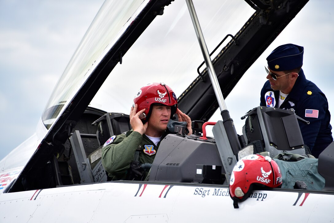 Todd Heap, former tight end for the Baltimore Ravens, puts his helmet on in preparation for a flight with Maj. Jason Markzon, Advance Pilot/Narrator for the U.S. Air Force Demonstration Squadron “Thunderbirds”, on Joint Base Andrews, Md. May 9, 2019. After arriving at JBA, the Thunderbirds met with Heap and practiced their performance in preparation for the 2019 JBA Legends in Flight Air & Space Expo. (U.S. Air Force photo by Airman 1st Class Noah Sudolcan)