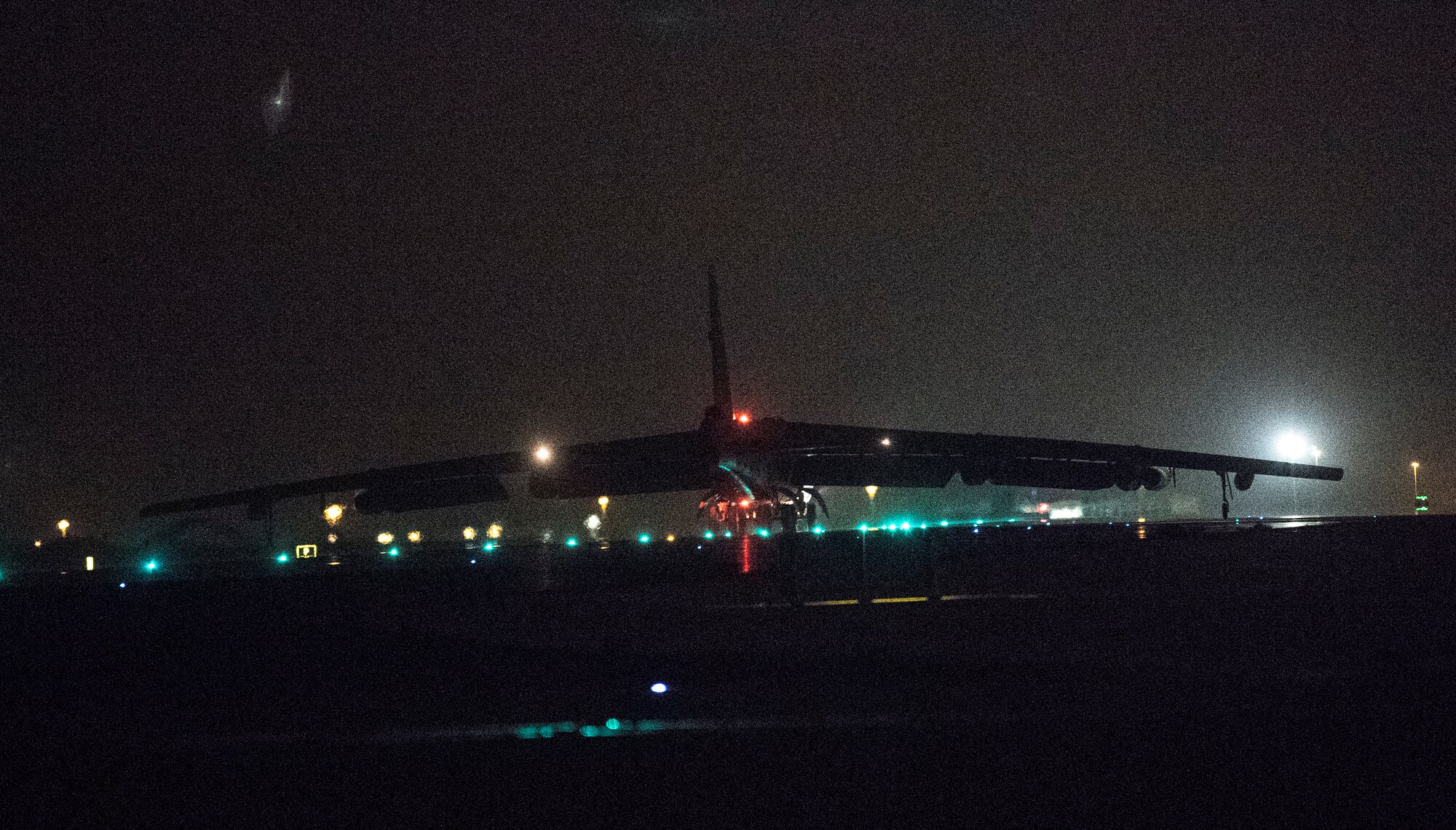 A photo of B-52 landing at night.