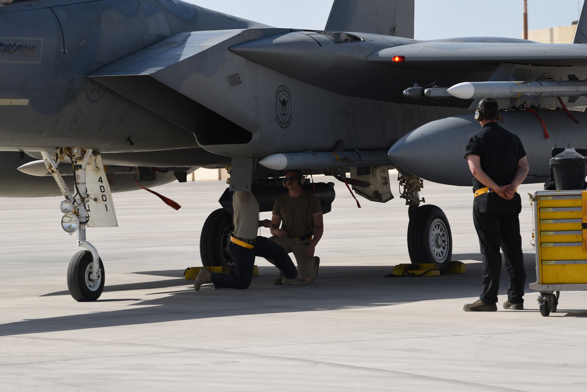 A photo of Airmen performing check on an F-15.