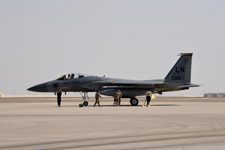 A photo of Airmen working on an F-15.