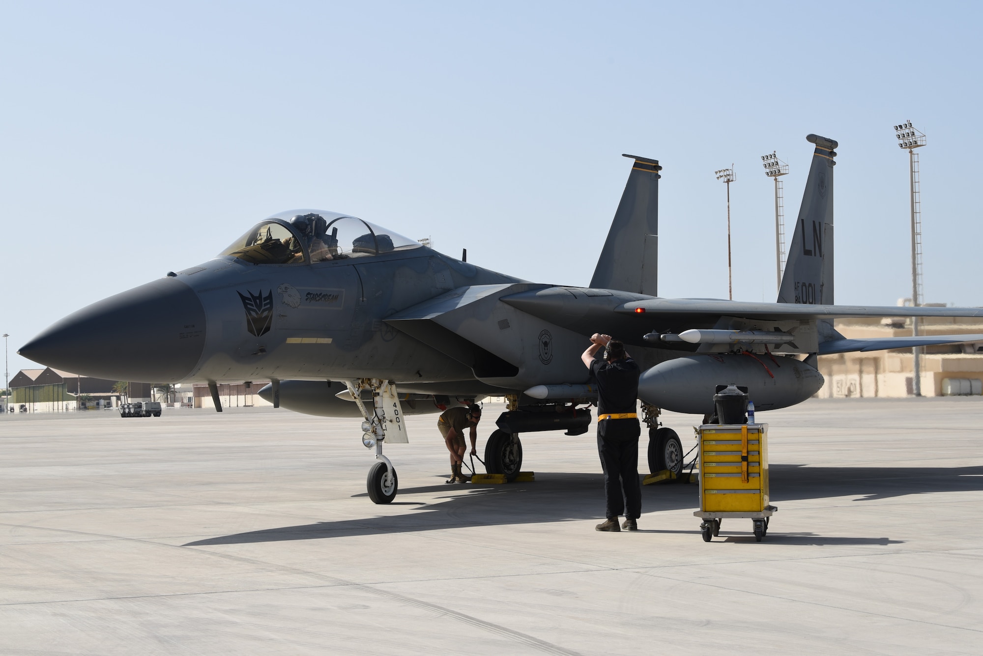 A photo of an Airman standing next to an F-15.