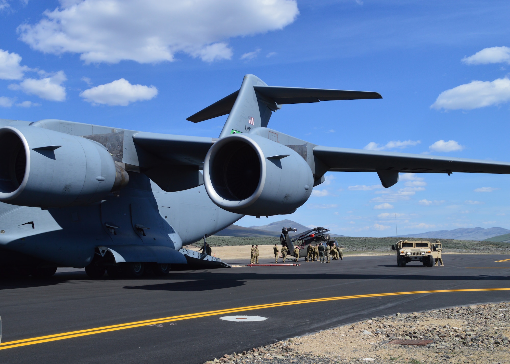 446th Airlift Wing loadmasters and active duty Soldiers assigned to unload a UH-60 Black Hawk from a C-17 Globemaster III at Selah airstrip May 1, 2019. It was the first time Reserve Citizen Airmen had utilized the newly refurbished runway at Yakima Training Center.