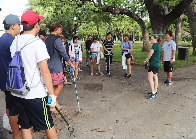 HONOLULU, Hawaii (April 27, 2019) -- Honolulu District Commander Lt. Col. Kathryn Sanborn (second from right) talks to Punahour JROTC cadets about her U.S. Army Corps of Engineers career and the importance of participating in community service projects while serving in the U.S. Army prior to Honolulu District's 2019 Earth Day event. Liistening at right is Punahou School JRTOC program Commander Lt. Col. (ret.) Robert Takao.