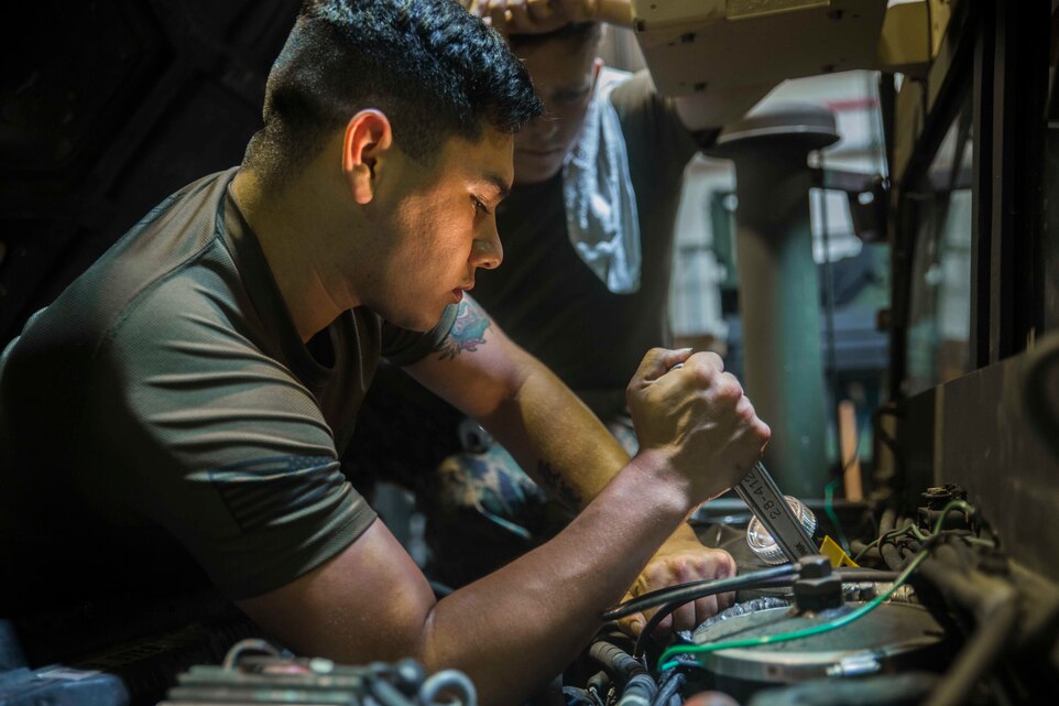 Lance Cpl. Johnjacob R. Carillo, a motor transportation mechanic with the Command Element of the 31st Marine Expeditionary Unit, works on the engine of a Humvee at Camp Hansen, Okinawa, Japan, Aprih 18, 2019.
