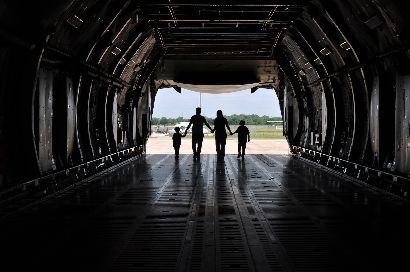 A 433rd Airlift Wing member and family walk through a static C-5M Super Galaxy May 5, 2019 at Joint Base San Antonio-Lackland, Texas.