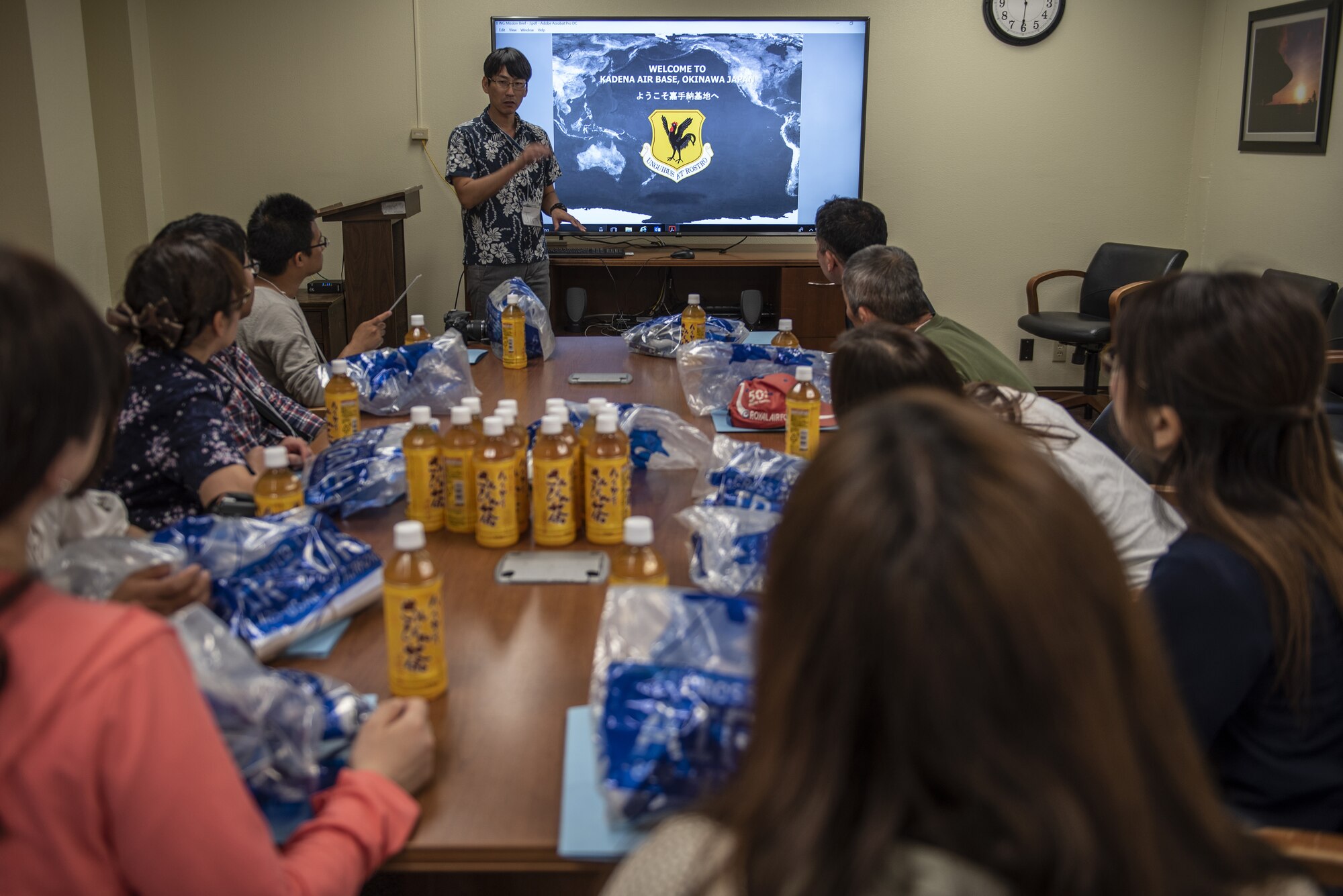 Jin Hiya, 18th Wing public affairs media relations specialist, briefs tour participants during a base tour of Kadena Air Base, Japan, May 8, 2019. The participants received a base mission brief and F-15 Eagle static display at Naha Air Base before traveling to Kadena for an 18th Wing mission brief and KC-135 Stratotanker static display. (U.S. Air Force photo by Tech. Sgt. Matthew B. Fredericks)