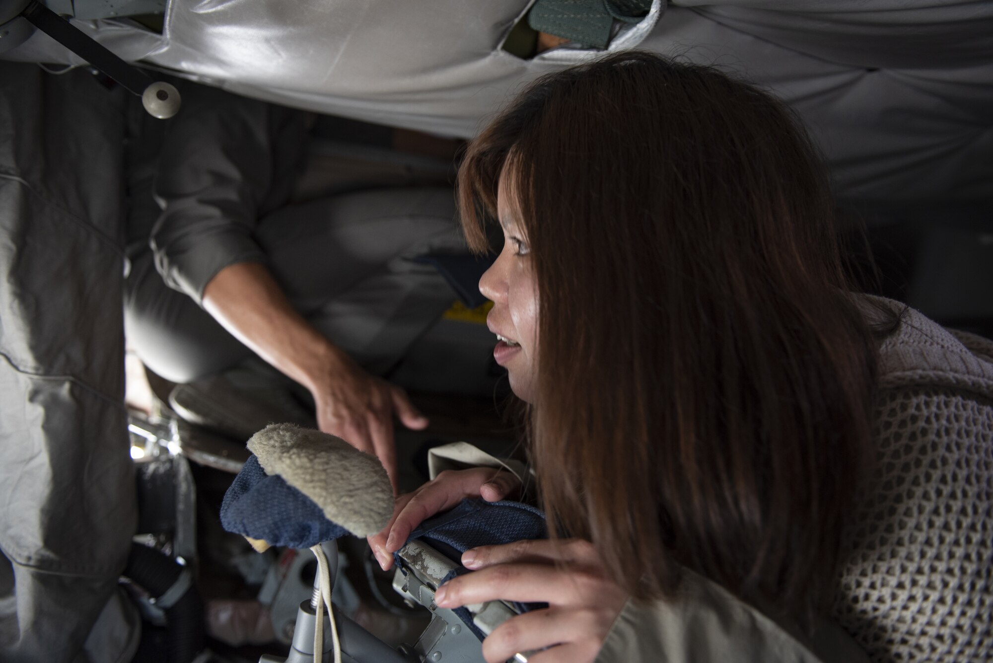 A tour participant looks out the window of a KC-135 Stratotanker during a base tour of Kadena Air Base, Japan, May 8, 2019. The participants received a base mission brief and F-15 Eagle static display at Naha Air Base before traveling to Kadena for an 18th Wing mission brief and KC-135 Stratotanker static display. (U.S. Air Force photo by Tech. Sgt. Matthew B. Fredericks)