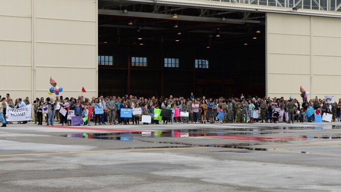 Families eagerly await the return of deployed 31st Fighter Wing Airmen at Aviano Air Base, Italy, May 9, 2019.  Through coalition support, the deployed Airmen’s efforts helped re-strengthen the local government in the fight against extremist groups within the Southwest Asia region. (U.S. Air Force photo by Senior Airman Kevin Sommer Giron)