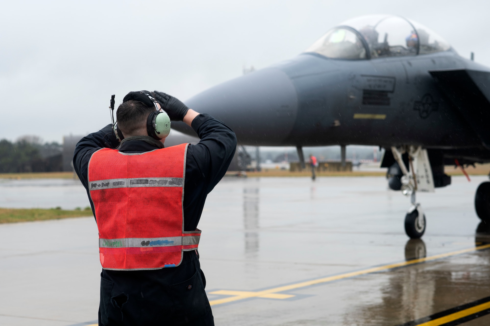 A crew chief assigned to the 492nd Aircraft Maintenance Unit marshals an F-15E Strike Eagle at Royal Air Force Lakenheath, England, May 8, 2019.The 492nd AMU Airmen maintain the world's premier multi-role fighter, the F-15E Strike Eagle to ensure RAF Lakenheath remains combat-ready. (U.S. Air Force photo by Senior Airman Malcolm Mayfield)