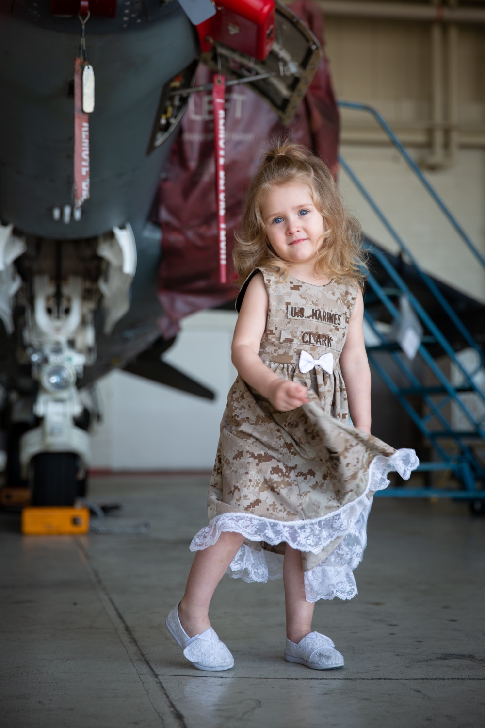 Amelia Clark poses for a photo while waiting for her father’s return home during a homecoming ceremony at Marine Corps Air Station Cherry Point, North Carolina, April 25, 2019. Marines from Marine Attack Squadron 223 returned from a deployment with Special Purpose Marine Air-Ground Task Force - Crisis Response - Africa 19.1. Amelia Clark is the daughter of Mitchell Clark, an aircraft intermediate level hydraulic/pneumatic mechanic with Marine Aviation Logistics Squadron 14, Marine Aircraft Group 14, 2nd Marine Aircraft Wing. (U.S. Marine Corps photo by Cpl. Cody Rowe)