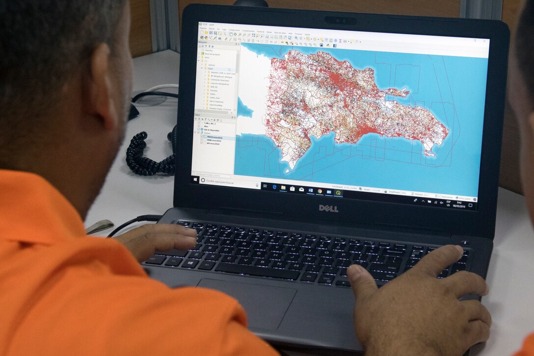 A communications operator with the Dominican Republic Ministry of Public Works and Communications creates virtual maps that depict weather effects like flooding in various regions of the Dominican Republic at the Emergency Operations Center in Santo Domingo, May 8, 2019.