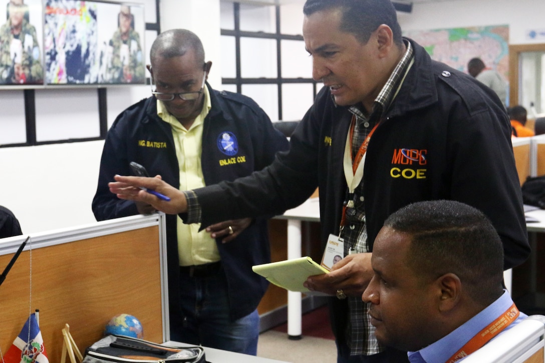 Liaisons from the Dominican Republic Ministry of Public Works and Communications and other civil organizations coordinate emergency-response efforts at the Emergency Operations Center in Santo Domingo, May 8, 2019.