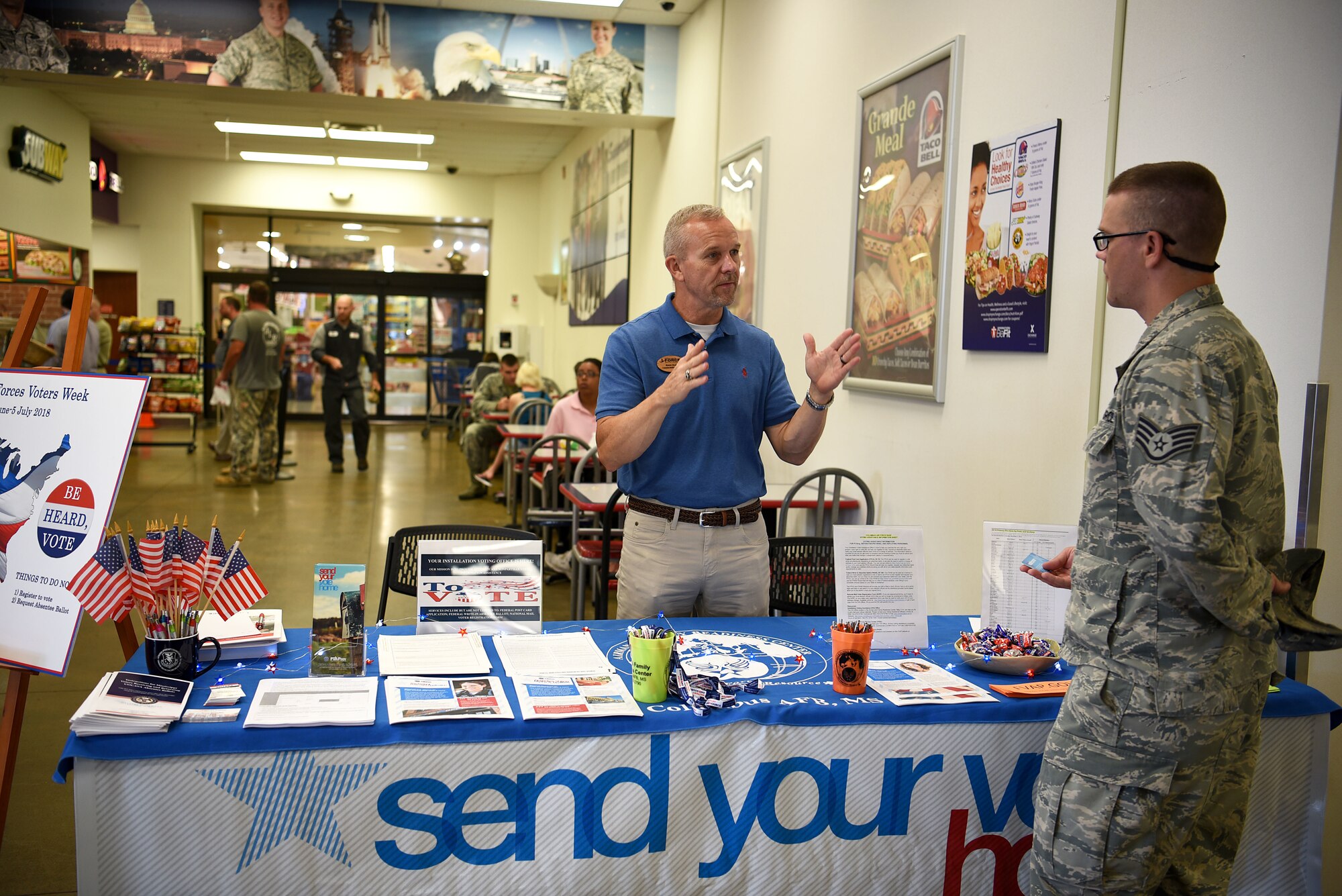 James Brady, 14th Force Support Squadron community readiness specialist and Installation Voting Assistance Officer for Columbus Air Force Base, talks with Staff Sgt. Cory Henning, 14th Civil Engineer Squadron NCO in charge of emergency management, during Armed Forces Voters Week, June 27, 2018 in the Base Exchange on Columbus Air Force Base, Miss. Though federal election years have a large effect on the voting community and activity, elections are happening across the country every year. (U.S. Air Force photo by Airman 1st Class Keith Holcomb)