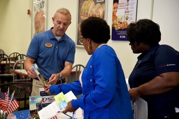 James Brady, 14th Force Support Squadron community readiness specialist and installation voting assistance officer for Columbus Air Force Base, talks with people during Armed Forces Voters Week, June 27, 2018, in the Base Exchange on Columbus AFB, Miss. Voting is an essential part of society, enabling citizens the ability to voice their opinions and choose the leaders of tomorrow. (U.S. Air Force photo by Airman 1st Class Keith Holcomb)