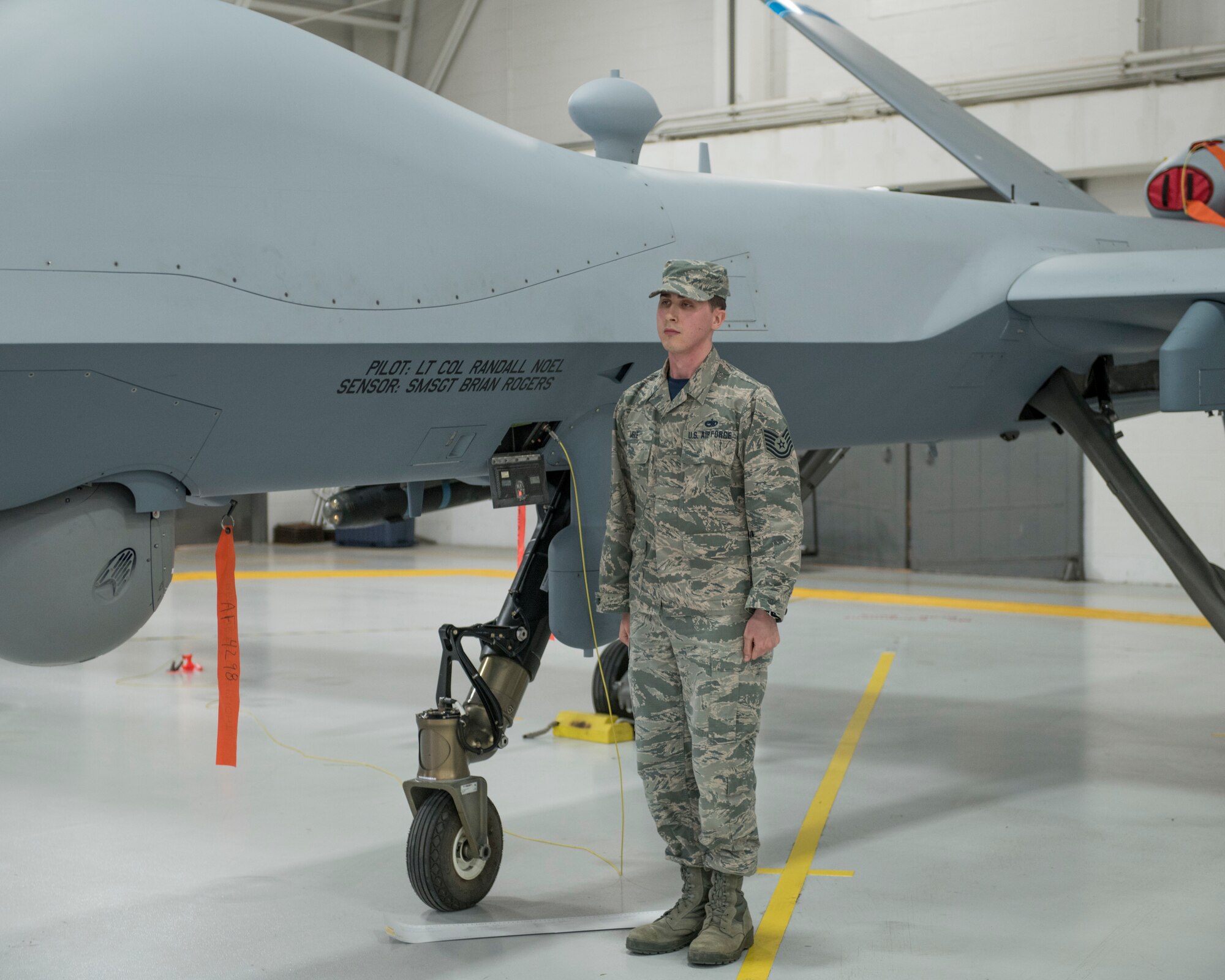 Staff Sgt. Mele ceremoniously unveils the name of the 491st Attack Squadron commander and their Dedicated Crew Chief on the side of an MQ-9 Reaper, during a squadron activation and assumption of command ceremony, May 8, 2019, on Hancock Field Air National Guard Base, N.Y. Lt. Col. Randall Noel, the 491st ATKS commander, formerly led the 6th and 16th Attack Squadrons on Holloman Air Force Base, N.M., as the Director of Operations. (U.S. Air Force photo by Airman 1st Class Kindra Stewart)