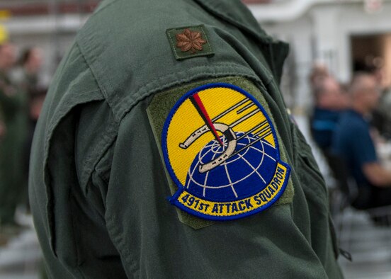 Maj. Chris Engelken, 491st Attack Squadron's assistant director of operations, ceremoniously attaches a patch to his uniform, during a squadron activation and assumption of command ceremony, May 8, 2019, on Hancock Field Air National Guard Base, N.Y. The 491st ATKS' patch is a historic emblem that was last designed in 1944. (U.S. Air Force photo by Airman 1st Class Kindra Stewart)