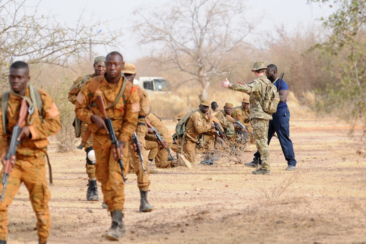 Men train with weapons.