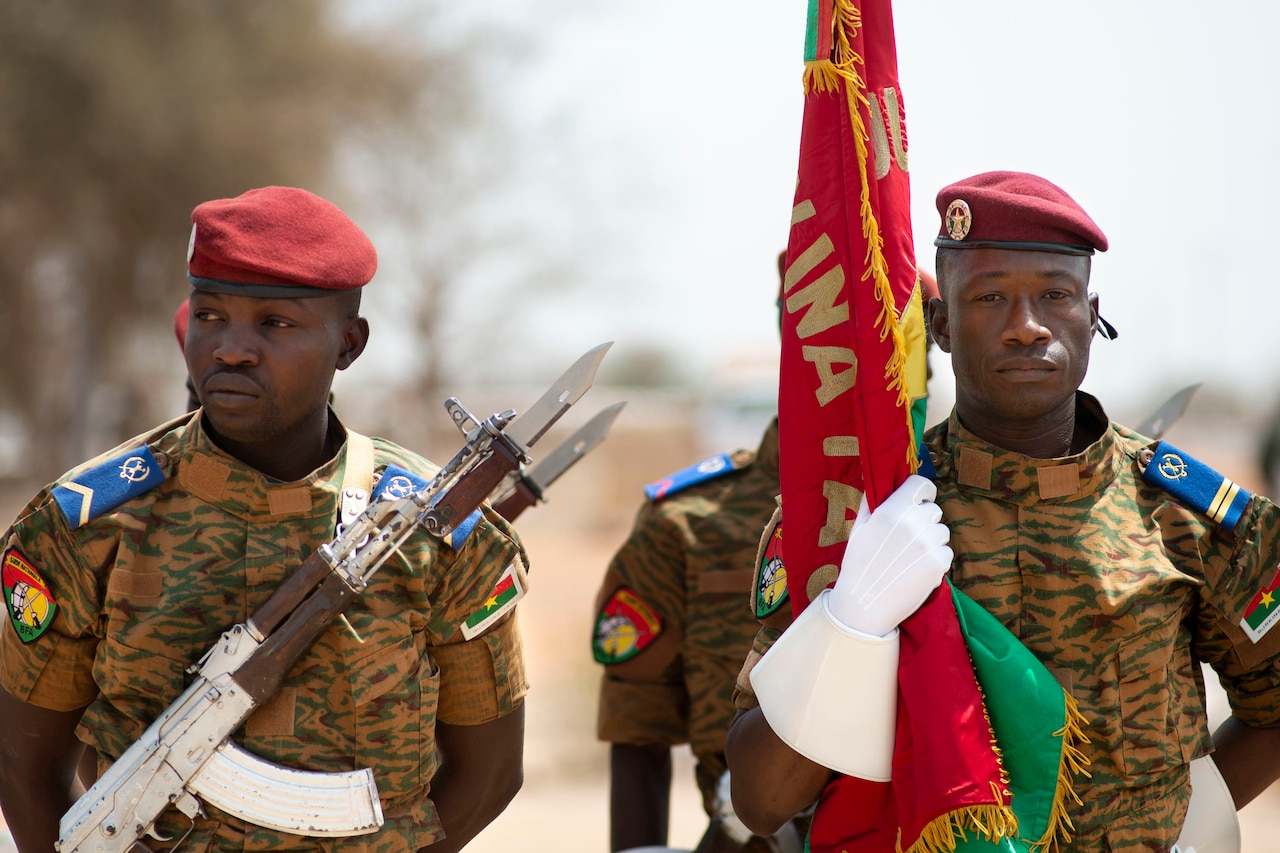 A military honor guard stands at attention.