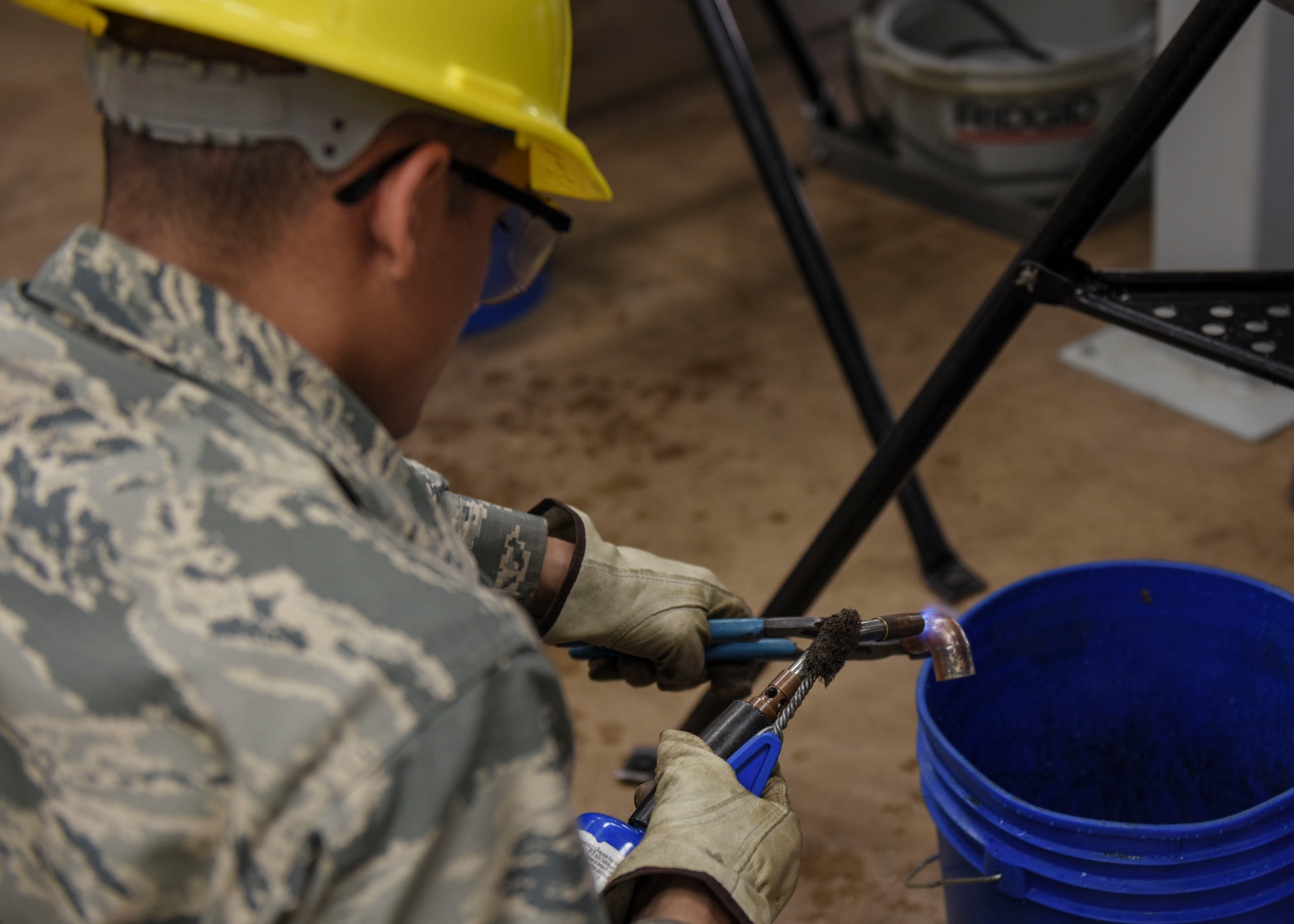 Airman Basic Ruben Segura, 366th Training Squadron water and fuels systems maintenance apprentice course student, prepares a piece of copper for soldering at Sheppard Air Force Base, Texas, May 8, 2019. Soldering is a process in which two or more items are joined together by melting and putting a filler metal into the joint. This process allows for the creation of a water channel from a water source to its various destinations. (U.S. Air Force photo by Senior Airman Ilyana A. Escalona)