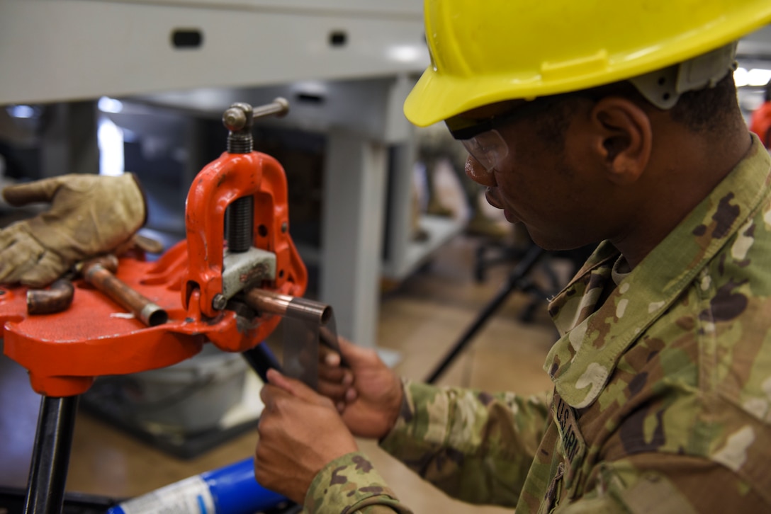 U.S. Army Private Antonio Boswell, 366th Training Squadron water and fuels systems maintenance apprentice course student, sands a copper line to prepare it for soldering at Sheppard Air Force Base, Texas, May 8, 2019. Proper interior plumbing is key to a good quality of life for personnel base wide. Upon graduation, these students will have acquired the skills needed to contribute to the access of clean water for everyday use across the installation. (U.S. Air Force photo by Senior Airman Ilyana A. Escalona)