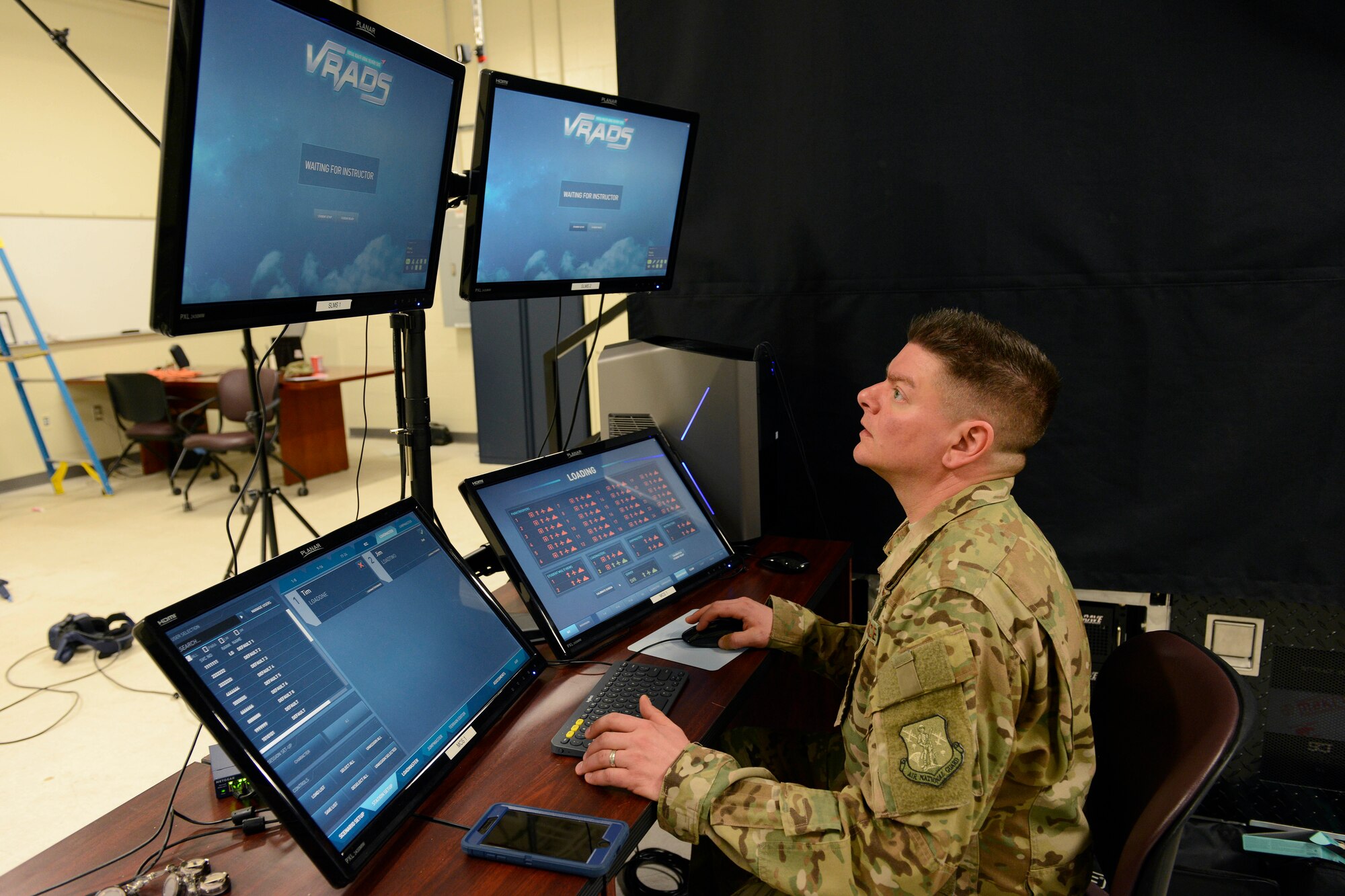 Master Sgt. Joseph Amato, 103rd Operations Group Evaluator Loadmaster, monitors the Virtual Reality Aerial Delivery Suite system during a training session at Bradley Air National Guard Base on March 29, 2019. The VRADS system is designed to supplement training for loadmasters in a realistic virtual atmosphere. (U.S. Air Force photo by Staff Sgt. Chad Warren)