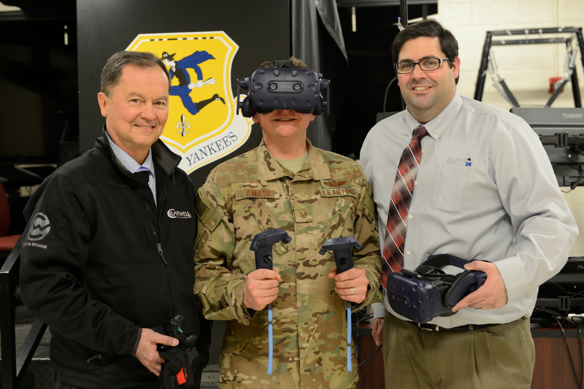 Bill Ehler, Business Development Manager of Capewell Aerial Systems (left), Master Sgt. Joseph Amato, 103rd Operations Group Evaluator Loadmaster, and Jared Burns, Director of Operations of Capewell Aerial Systems, take a break during a training session for the Virtual Reality Aerial Delivery Suite at Bradley Air National Guard Base on March 29, 2019. The VRADS system is designed to supplement training for loadmasters in a realistic virtual atmosphere. (U.S. Air Force photo by Staff Sgt. Chad Warren)