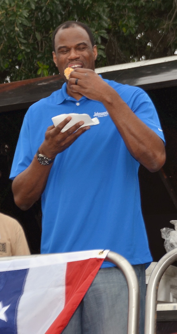 Former San Antonio Spurs legend David Robinson spoke to military spouses and children, signed autographs and shot some hoops during the Military Spouse Appreciation Day event at Joint Base San Antonio-Fort Sam Houston May 9. After his remarks, fans swarmed Robinson as he signed autographs, basketballs and Spurs memorabilia. He posed for photos and got to play basketball with some of the fans. Robinson was able to enjoy the food, including the sausage grilled at the event before heading out.