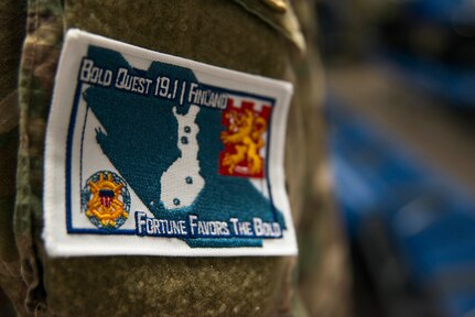 A patch worn by members of the 290th Joint Communications Support Squadron for exercise Bold Quest at MacDill Air Force Base, April 8, 2019. The patch pictures the country of Finland and the four locations Bold Quest exercises in. Bold Quest was originally conceived in 2001 as an Advanced Concept Technology Demonstration (ACTD), with the first operational demonstration in 2003. (U.S. Air Force photo by Airman 1st Class Frank Rohrig)