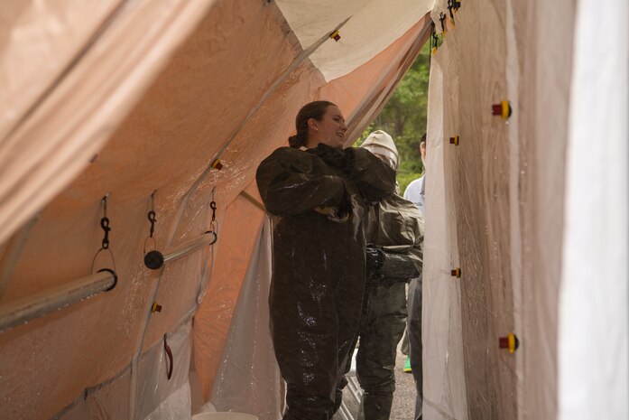 Senior Airman Kayla Morales, a dental assistant assigned to the 628th Aerospace Medical Squadron, decontaminates herself during an exercise May 9, 2019, at Joint Base Charleston, S.C.